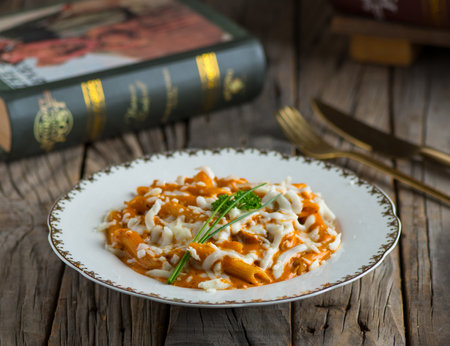 penne rose pasta served in a dish isolated on wooden background side view of pastaの写真素材