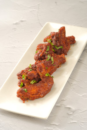 Chicken Wings BBQ served in a dish isolated on background side view of fastfoodの写真素材