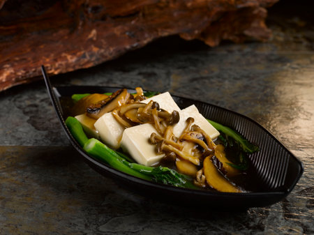 Braised Beancurd with Assorted Mushroom served in dish isolated on table top view of foodの写真素材