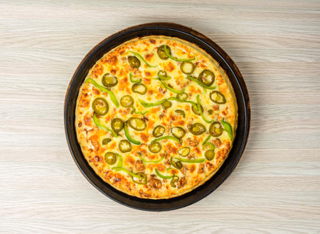 Chicken Fajita Pizza isolated on wooden background, spiced chicken cubes and cheese combination on bread, Italian food top viewの写真素材