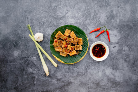 Seafood Tofu with spring onion, garlic, fish sauce served in bowl isolated on dark grey background top view of japanese foodの写真素材