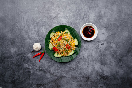 Garlic Fried Rice with fish sauce and salad salad served in dish isolated on dark grey background top view of japanese foodの写真素材