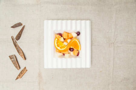 Sweet mixed fruit orange, apple, blueberry served in a dish isolated on table top view of indian foodの写真素材