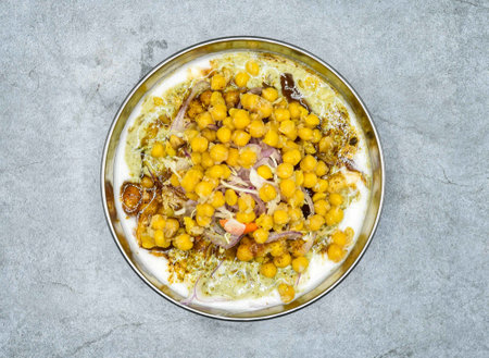 Spicy chana chaat masala with yogurt served in dish top view of indian and pakistani food