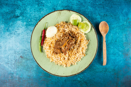 spicy beef pulao, polao, biryani, mandi, kacchi with egg and salad served in dish isolated on table...