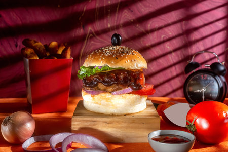 BBQ chicken cheese burger with french fries, potato and tomato slice isolated on wooden board side view on table fast foodの写真素材