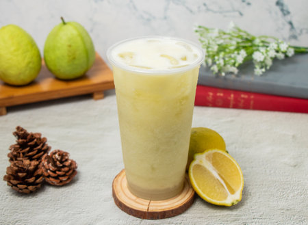Guava Lemonade iced tea served in disposable glass isolated on background top view of taiwan drinkの写真素材