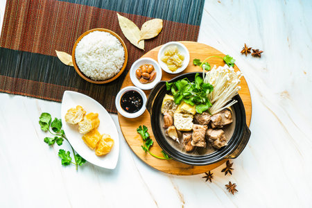 Pork Belly Bak Kut Teh with rice and sauce served in dish isolated on wooden board top view on marble background hong kong foodの写真素材