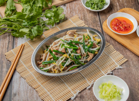 Duck intestines mixed vegetables with chilli sauce, noodles, spoon and chopsticks served in dish isolated on napkin top view of hong kong foodの写真素材