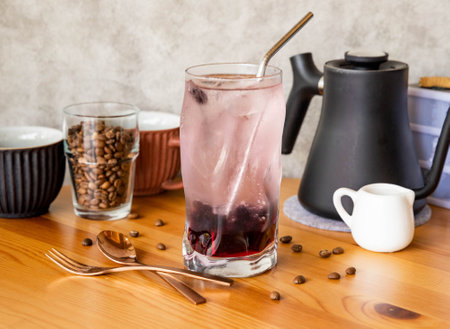 Glimmer Sparkling Drink with Cranberry with coffee beans, fork, spoon served in glass isolated on...