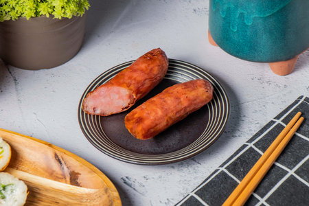 Grilled Sausages served dish with chopsticks isolated on napkin side view of taiwanese foodの写真素材