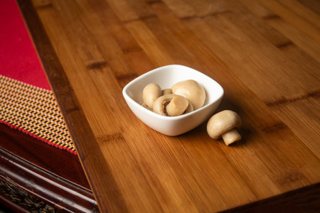 Fresh Mushroom served in bowl isolated on wooden table top view of indian foodの写真素材
