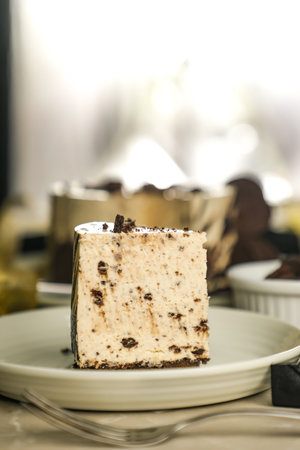 Oreo Cheesecake slice include chocolate, cream, sugar with fork and flowers served in plate isolated...