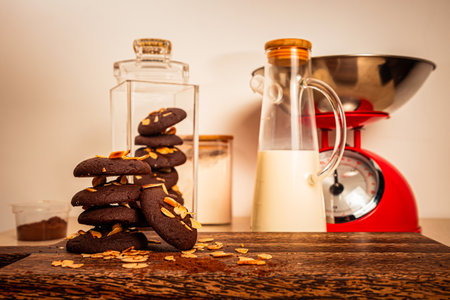 Tasty Chocolate cookie with jug of milk served on wooden board side view of healthy breakfast on tableの写真素材