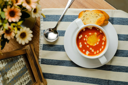 Creamy Tomato Basil Soup served in bowl isolated on napkin top view of chinese soupの写真素材
