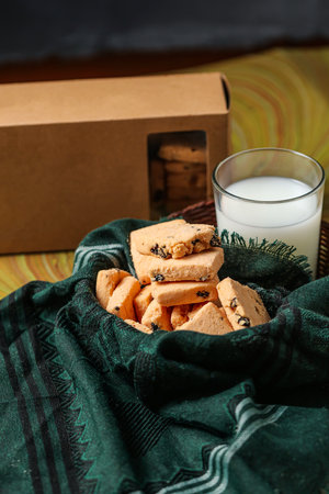 Crunchy cookies biscuits served in plate with cookie box and glass of milk isolated on table side view of american cafe baked foodの写真素材