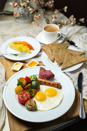 English breakfast with vegetable salad include tomato, potato, lettuce leaf and carrot with tea, coffee, and sweet melon served on food table top view healthy breakfastの写真素材