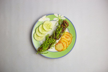 Beed Seekh kabab with tomato and cucumber served in plate isolated on background top view of bangladeshi, indian and pakistani traditional spicy foodの写真素材