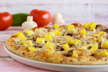 Hawaiian Pizza closeup topping with capsicum, mushroom, tomato and olives served in dish isolated on table side view of arabic fastfoodの写真素材