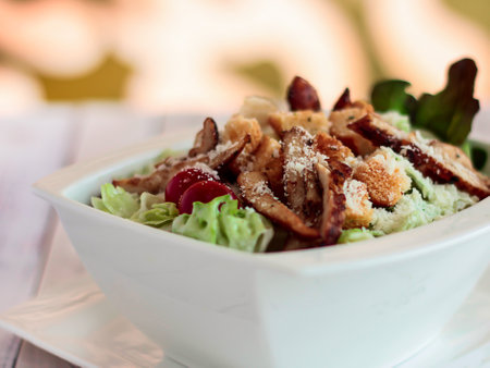CHICKEN CAESAR SALAD with lettuce leaf served in dish isolated on table closeup top view of healthy organic foodの写真素材