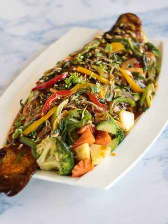 THAI RED RIVER FISH served in dish isolated on table closeup top view of grilled seafoodの写真素材