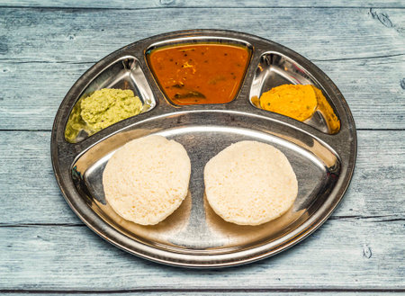 podi idli thali with curry served in dish isolated on wooden table top view of indian spicy foodの写真素材