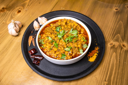 dal chana and mezbani gosht served in dish isolated on wooden background top view indian spices,...