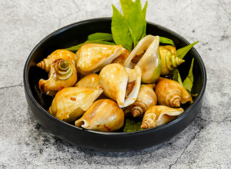 snail steamed with lemongrass or oc nhay hap xa, bo toi, muoi tac stir fried gonggo served in dish...