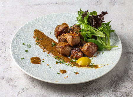 chaota grilled beef cubes tikka boti kabab with lemon and green leaves served in dish isolated on grey background top view of singapore foodの写真素材