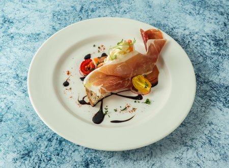 Bruschetta meat sandwich with cheery tomato and lemon served in plate isolated on background top...