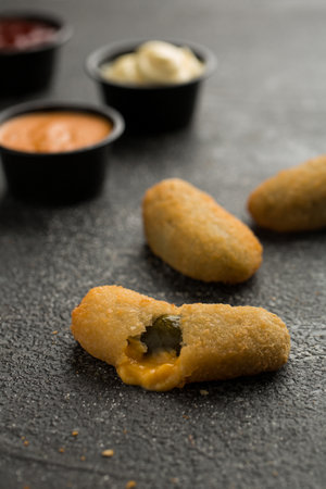 Jalapeno Poppers with dip sauce isolated on dark grey background side view of fast food sandwichの写真素材