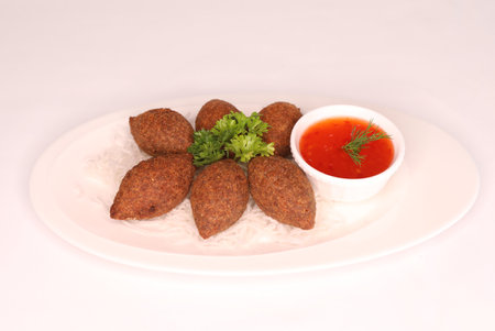 MEAT KIBBEH with chili sauce served in dish isolated on background side view of arab food