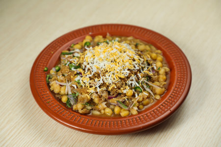 Spicy chotpot masla chaat with chana, chola, chilli served in dish isolated on table top view of...