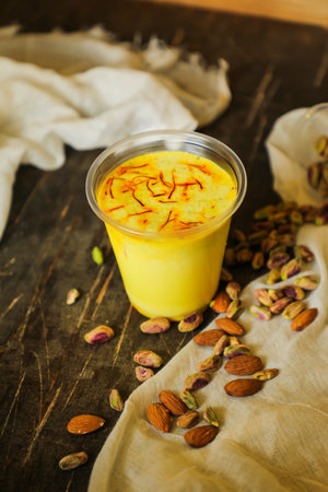 Badam sharbat, Almond milk syrup with saffron served in glass isolated on table top view of drinkの写真素材