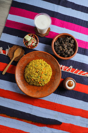 Kala bhuna khichuri with salad, borhani and baked gulab jamun served in dish isolated on mat top...