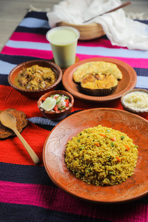 Achari Chicken Khichuri Combo with egg plant and omelet, borhani, salad and Chui Pitha served in...