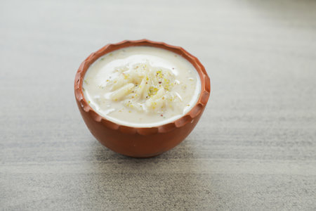 chui pitha, kheer, firni served in pot isolated on mat top view of indian, bangali and pakistani...