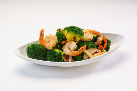 Broccoli, Shrimp Balls and mushroom in XO Sauce served in dish isolated on wooden table side view of hong kong fast foodの写真素材