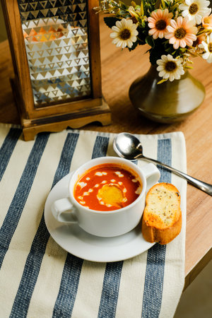 Creamy Tomato Basil Soup served in bowl isolated on napkin side view of chinese soupの写真素材