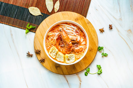 Prawn Laksa noodles served in bowl isolated on wooden board top view on marble background hong kong foodの写真素材