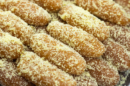 Lal Langcha, Lencha, Lengcha or Lemcha coating with coconut texture closeup side view of Indian, pakistani and bangladeshi sweet dessert foodの写真素材