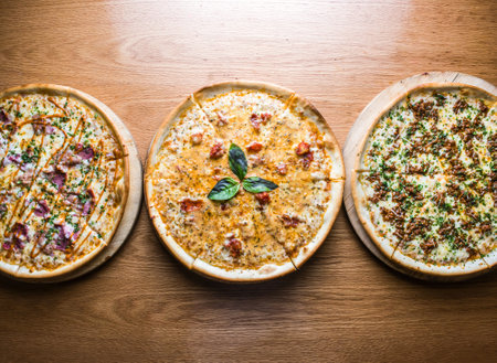 Assorted Pizza Verity, Classic Margherita Pizza, BBQ pulled pork pizza, Bolognese topped with melted cheese served on wooden board isolated on table background top view of italian cousinの写真素材