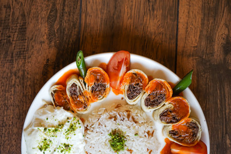 Turkish Meat Beyti Kebab with rice and yogurt served in plate isolated on wooden table closeup top view of turkish fast foodの写真素材