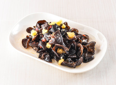 Hot and sour cloud fungus served in tray dish isolated on white background side view of hong kong foodの写真素材