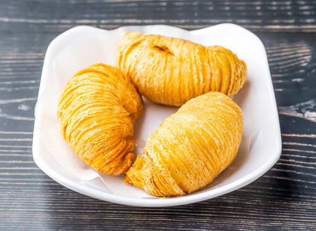Golden Carrot Puff Pastry served in dish isolated on wooden table side view