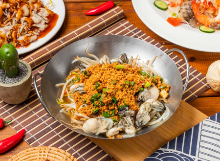 Bean crispy fresh oysters noodles with spring onion and chopsticks served in dish isolated on table side view taiwanese foodの写真素材