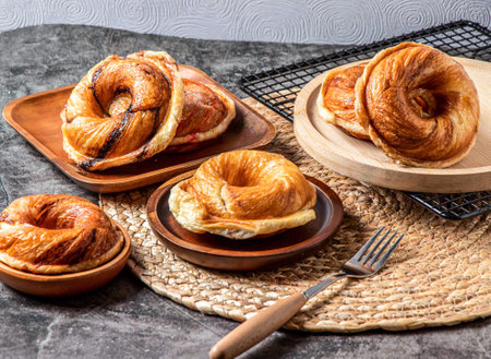 Assorted baked donuts verity, baked strawberry donuts, Cheese baked donuts, Brown sugar baked donuts, served in wooden dish isolated on table side view of dessertの写真素材