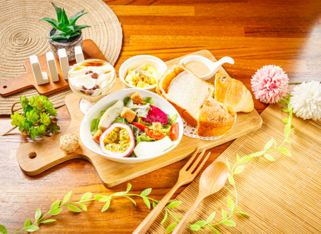 Vegetable and Fruit Salad with dragon fruit, passion fruit, cabbage, lettuce and tomato served in dish isolated on wooden table side viewの写真素材