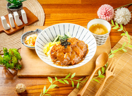 Japanese Curry Pork Chop Rice with Miso soup served in dish isolated on wooden table side viewの写真素材