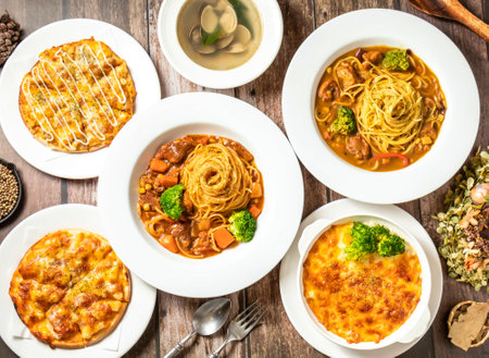 curry chicken noodles, calm soup, pineapple pizza, baked rice, Creamy Bacon Gratin with spoon and fork served in plate isolateda top viewの写真素材